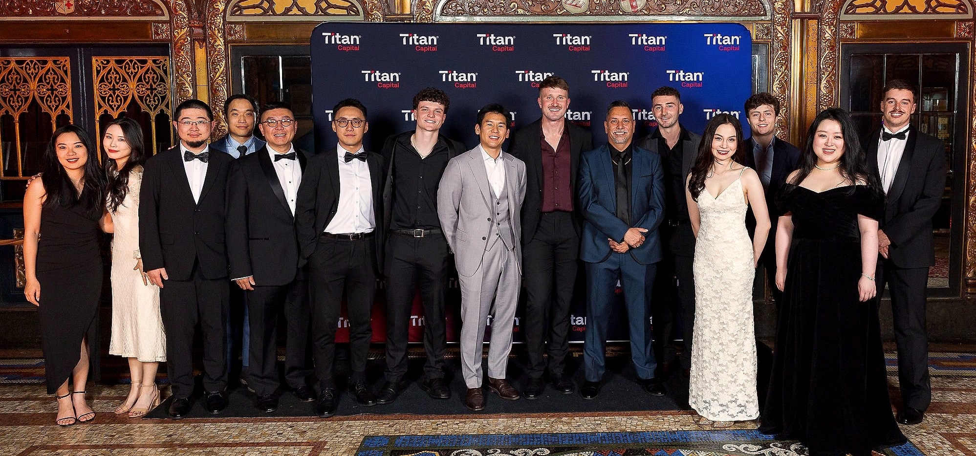 The Titan Capital team together in front of the Titan media wall at the 10th anniversary Gatsby Gala, State Theatre, Sydney